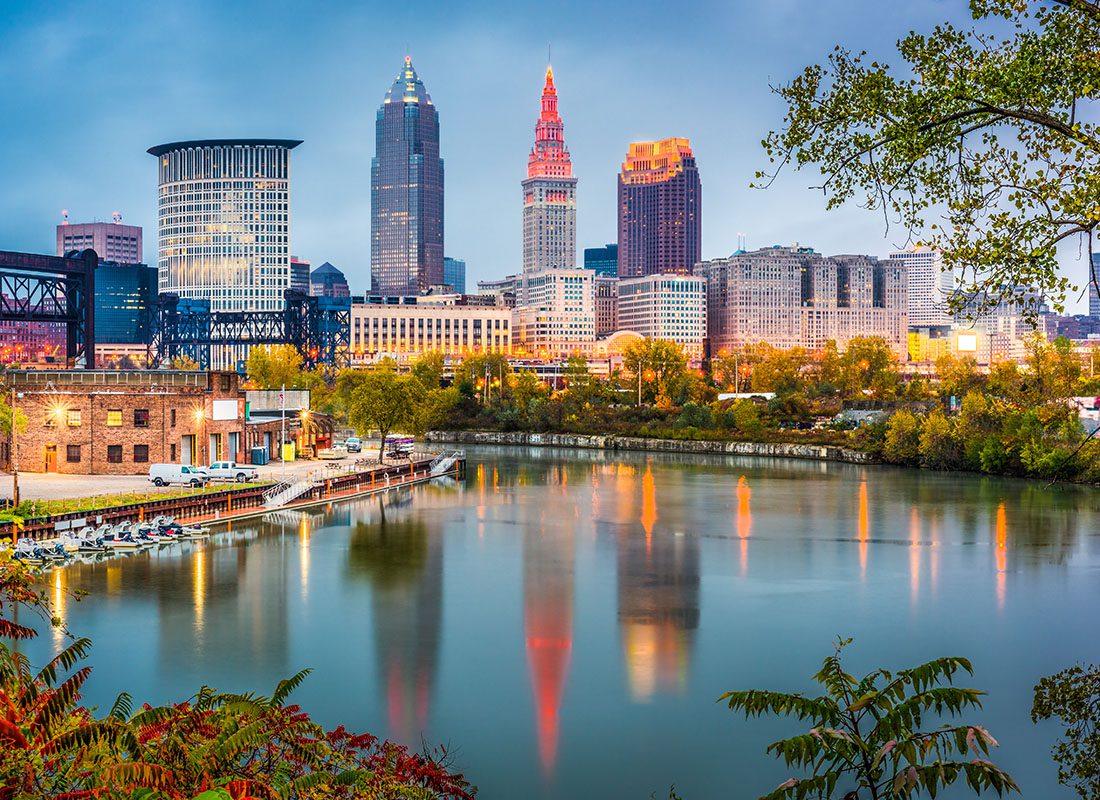 Contact - Aerial View of Cleveland, Ohio Displaying a Lake Reflecting Lights and Buildings